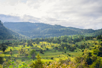 An impressive mountain landscape with a colorful sunset in the cloudy sky, a natural environment for outdoor travel