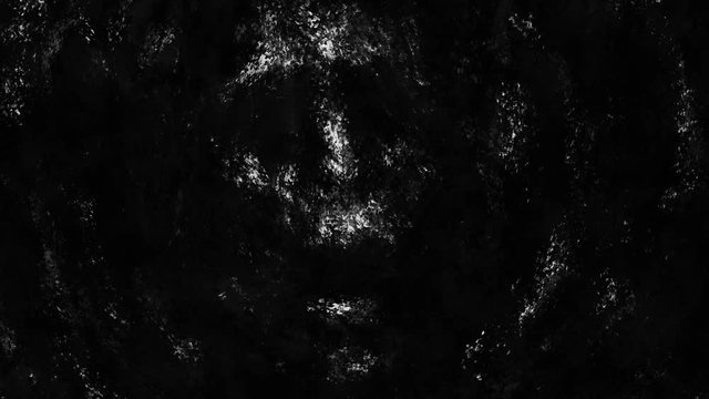 Spooky human face rises from the mud and screams drowning. Genre of horror. Black and white color background.