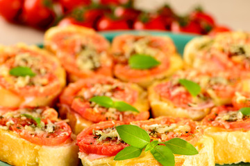 bruschetta with tomato, parmesan, olive oil, ham and oregano