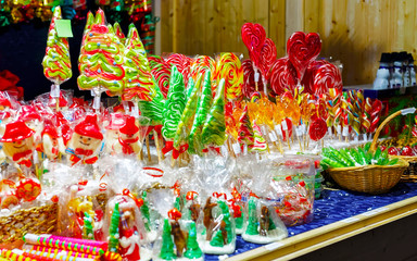 Lollipop candies in Christmas market in Lithuania Europe in winter. Sweet food at Lithuanian Night street Xmas and holiday fair European city or town, December. Vilnius