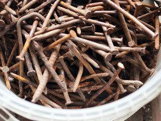 pile of old rusty bent construction nails
