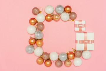 2020 New year composition. Stylish decor concept, shiny christmas baubles, gift boxes on pink backdrop. Flat lay, top view, copy space. Background for postcard, for desktop