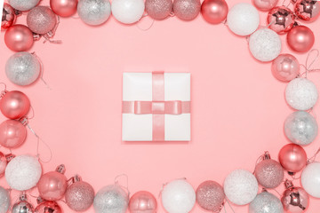 2020 New year composition. Stylish decor concept, shiny christmas baubles, gift box on pink backdrop. Flat lay, top view, copy space. Background for postcard, for desktop