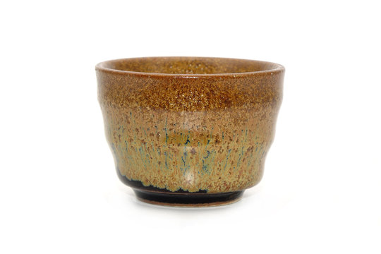 Japanese Sake cup Isolated on white background. Antique Japanese earthenware liquor cup.