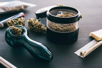 Cannabis legalisation. Marijuana smoking pipe CBD and THC on buds in cannabis. Macro Cannabis buds...
