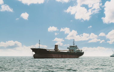 Logistics and transportation of International Container Cargo ship in the ocean at Sunshine sky,...