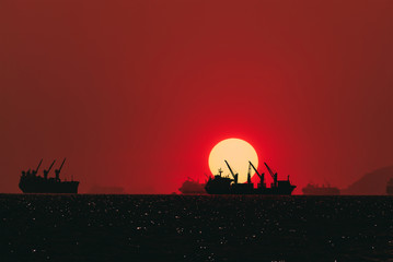 Fototapeta na wymiar Silhouette Logistics and transportation of International Container Cargo ship in the ocean at Sunshine sky, Freight Transportation, Shipping