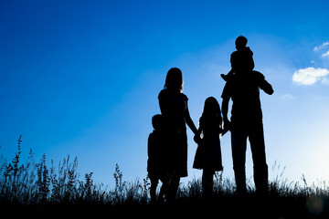 Fototapeta na wymiar happy family outdoors in the park silhouette