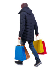 back view of man in winter jacket with shopping bags. © ghoststone