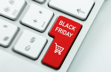 Computer notebook keyboard with inscriptions black friday and icon shopping cart on key. Black Friday E-commerce concept