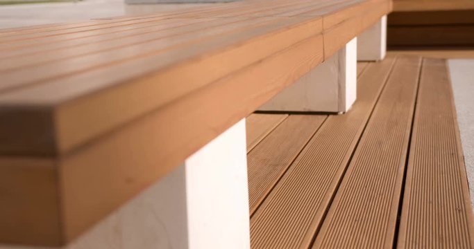 Modern beautiful wooden bench standing in the courtyard of an apartment building