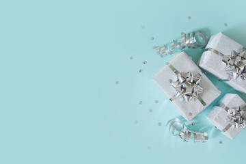 Christmas banner. Xmas silver and glitter gifts box, blue background. Horizontal poster, greeting card, headers, website. Decoration objects flat lay, top view