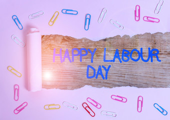 Handwriting text Happy Labour Day. Conceptual photo annual holiday to celebrate the achievements of workers Paper clip and torn cardboard placed above a wooden classic table backdrop