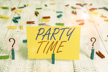 Writing note showing Party Time. Business concept for the right moment to celebrate and have fun in social event Crumbling sheet with paper clips placed on the wooden table