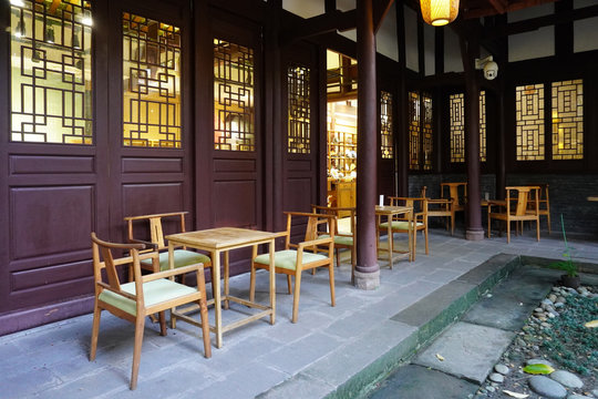 The outdoor chinese tea house with wooden table and chairs. People enjoying tea at Chengdu.