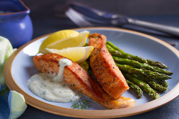 Salmon fish fillet with asparagus and creamy garlic sauce