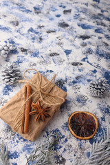 Christmas composition. Gift, cones from the Christmas tree and Christmas tree branches. Background for the New Year and Christmas. Vertical frame.
