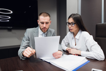 Business, office, law and legal concept - picture of man and woman hand signing contract paper