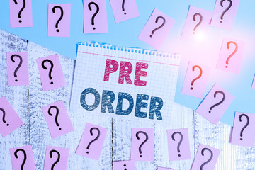 Text sign showing Pre Order. Business photo showcasing an order for a product placed before it is available for purchase Scribbled and crumbling papers with thick cardboard above wooden table