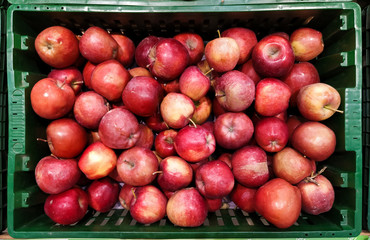 a box full of red apples in the store