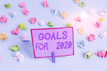 Conceptual hand writing showing Goals For 2020. Concept meaning The following things you want to have and achieve in 2020 Colored crumpled papers empty reminder blue floor clothespin