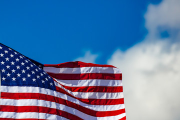 New american flag waving in front of a blue sky