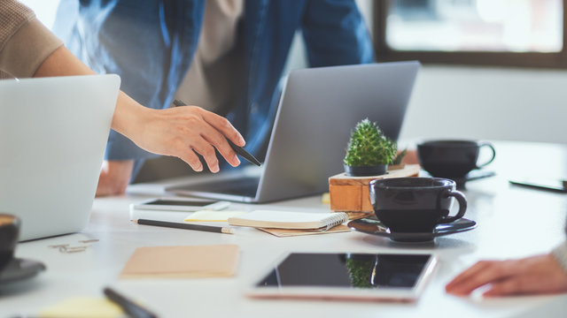 Group of businessman discussing and  working on laptop computer on the table in officeGroup of businessman discussing and  working on laptop computer on the table in office