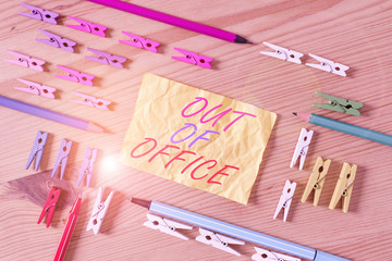 Text sign showing Out Of Office. Business photo showcasing Outside the job Nobody in business Break Leisure Relax time Colored clothespin papers empty reminder wooden floor background office