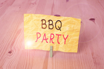 Conceptual hand writing showing Bbq Party. Concept meaning usually done outdoors by smoking meat over wood or charcoal Wooden floor background green clothespin groove slot office