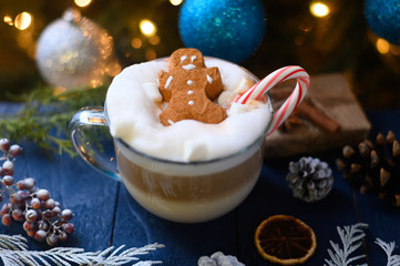 Fototapeta na wymiar Christmas and New Year. Marshmallow snowman in hot latte in a mug. On the background of Christmas trees and toys.