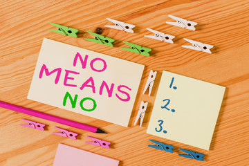 Text sign showing No Means No. Business photo showcasing Stop abuse gender violence Negative response Sexual harassment Colored clothespin papers empty reminder wooden floor background office