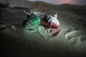 Christmas background with baubles, on snow, free space for text. Christmas decoration