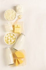 Dairy and dairy products on a white background. Milk, kefir, yogurt, butter, cheese assortment. Flat layout top view.