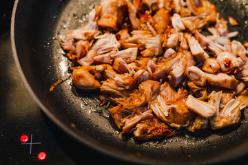 pulled jackfruit getting sauteed in a pan the fruit is used as mock chicken in vegan nutrition