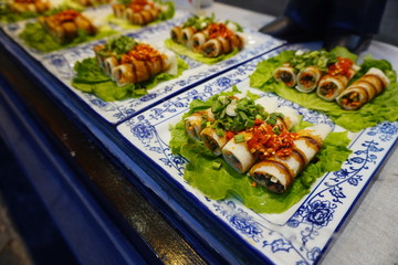 A restaurant that selling traditional vegetable spring roll at Jin li ancient town, China. It rolled with cabbage and other vegetable fillings inside a thinly wrapped cylindrical pastry.