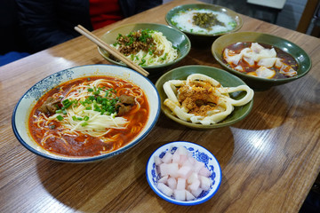 Variation of Sichuan style noodles like spicy noodle with pork intestines, Tian Shui Mian (sweet sauce, noodle), Zhajiang mian(soybean paste noodle), pork dumpling and some pickles as side dish.