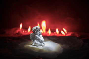 Little white guardian angel in snow. Festive background. Christmas and New Year concept. Selective...