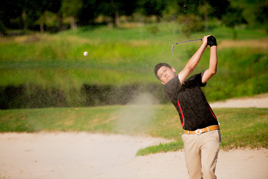  golfer  play  shot ball  from sand bunker
