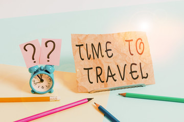 Conceptual hand writing showing Time To Travel. Concept meaning Moving or going from one place to another on vacation Mini size alarm clock beside stationary on pastel backdrop