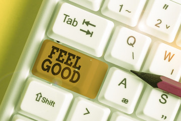 Word writing text Feel Good. Business photo showcasing relating to or promoting an often specious sense of satisfaction White pc keyboard with empty note paper above white background key copy space
