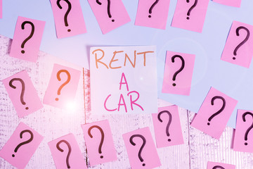 Word writing text Rent A Car. Business photo showcasing paying for temporary vehicle usage from one day to months Scribbled and crumbling papers with thick cardboard above wooden table