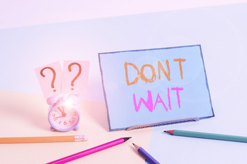Writing note showing Don T Wait. Business concept for Take action now and do something for a purpose Act quickly Mini size alarm clock beside stationary on pastel backdrop