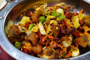 Traditional Stir fry pork knuckles with garlic and Sichuan chili and spices at Chengdu.