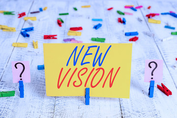 Writing note showing New Vision. Business concept for seeing some future developments Hopeful about the future Crumbling sheet with paper clips placed on the wooden table