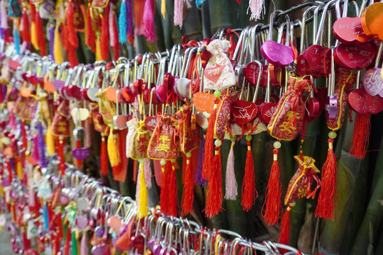Wishes tree on market place full of tourists on Jinli ancient street in Chengdu city downtown in Sichuan. Translation is "Let all wishes will be executed truly".