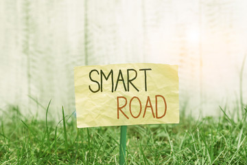 Handwriting text writing Smart Road. Conceptual photo number of different ways technologies are incorporated into roads Plain empty paper attached to a stick and placed in the green grassy land