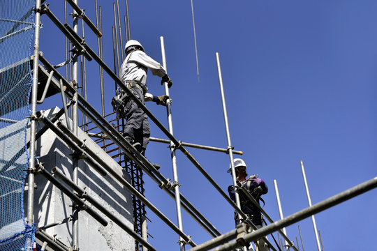 High-rise building site: steeplejack building up scaffolds