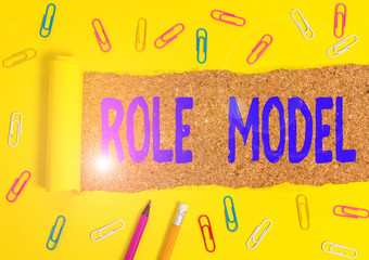 Conceptual hand writing showing Role Model. Concept meaning a demonstrating looked to by others as...
