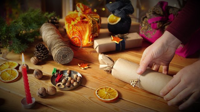 Eco-friendly gift box. Biodegradable brown parcel paper tied up with string &ndash; adding natural decorations. A waste-free Christmas. Reusable, compostable, recyclable wrapping 