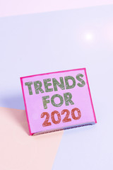 Word writing text Trends For 2020. Business photo showcasing list of things that got popular very quickly in this year Paper placed tilted above buffer wire on soft pastel multi colours backdrop